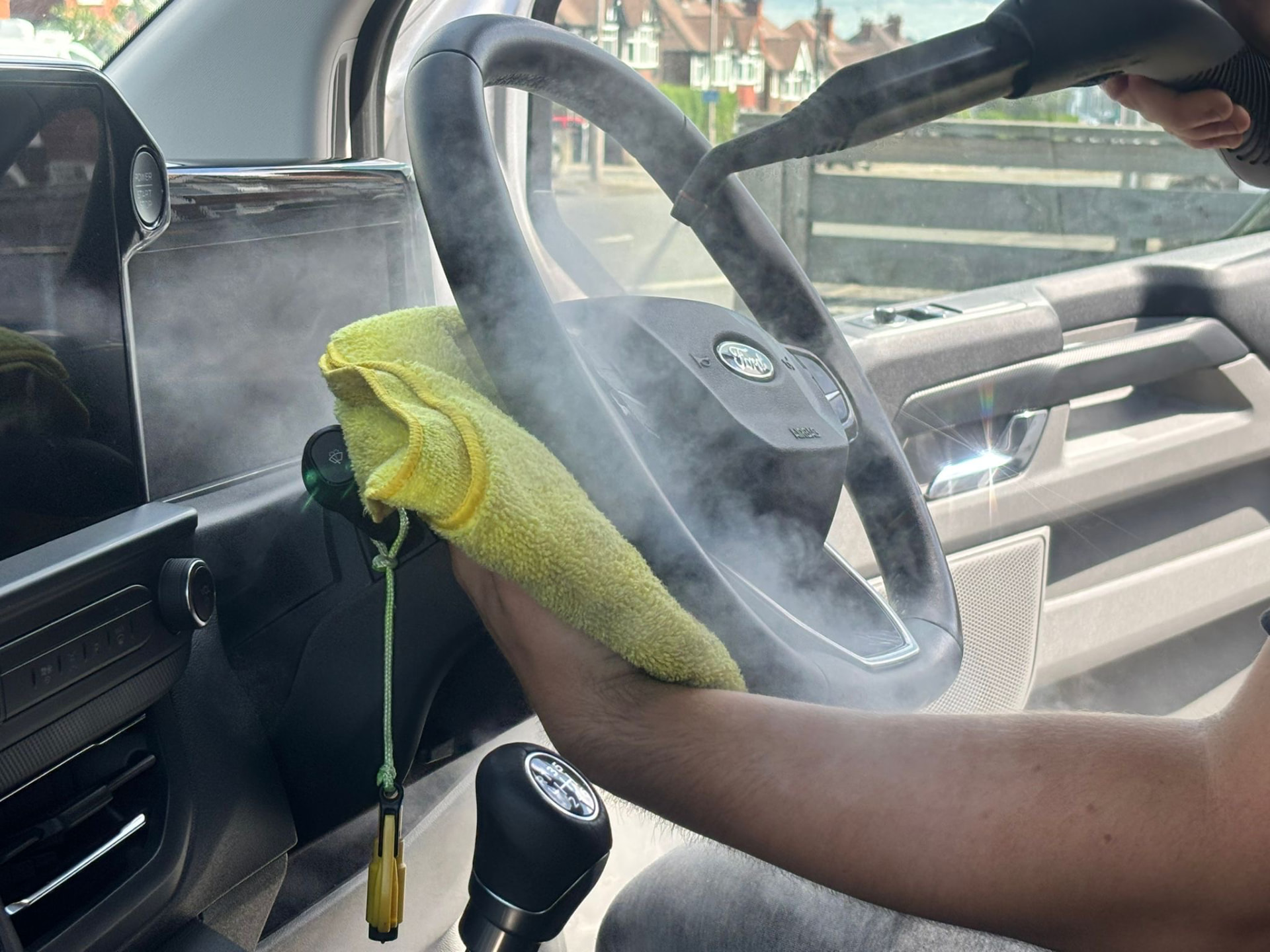 Steam cleaning a Ford steering wheel and dashboard
